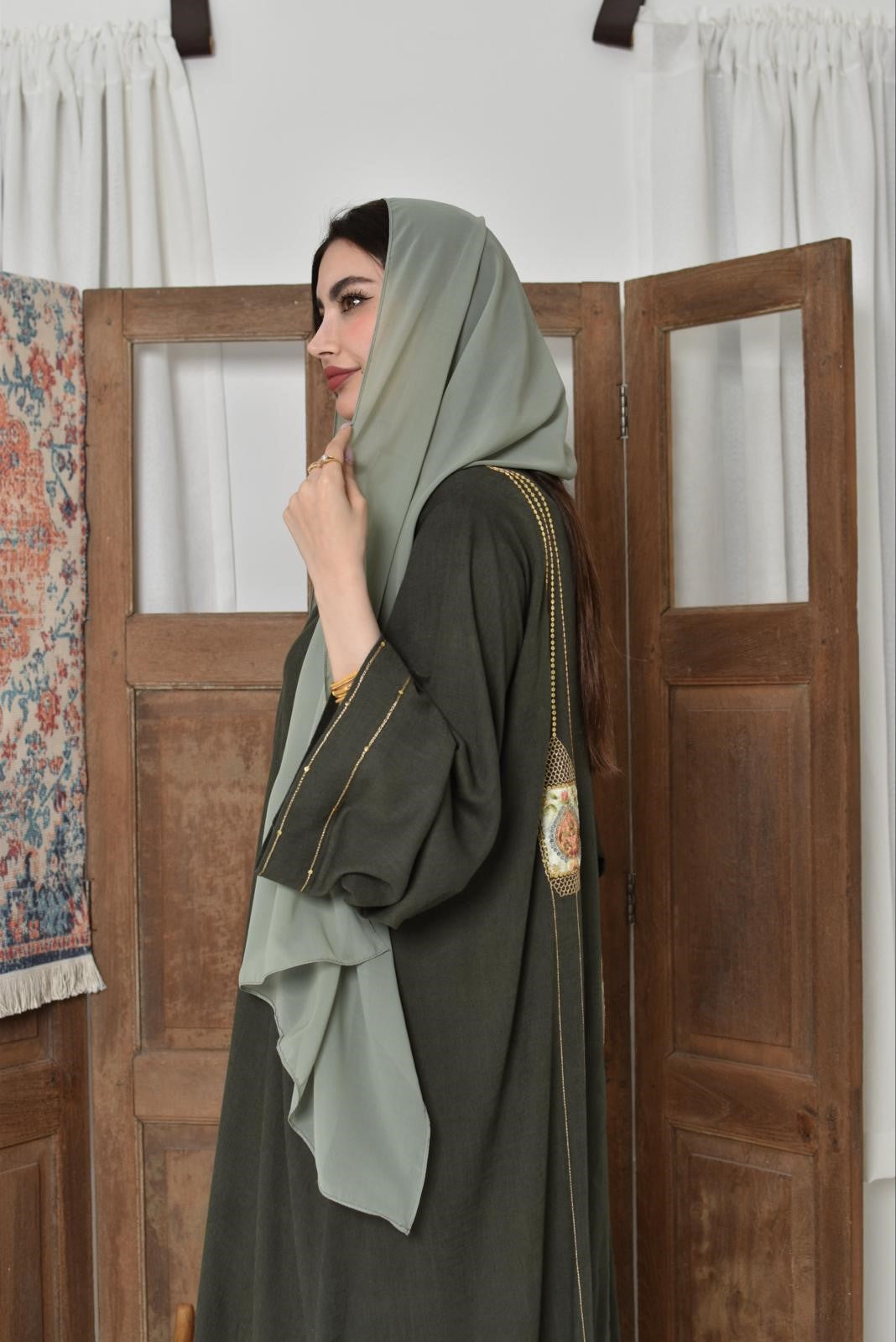 Green linen fabric abaya made of appliqué art with hand embroidery
