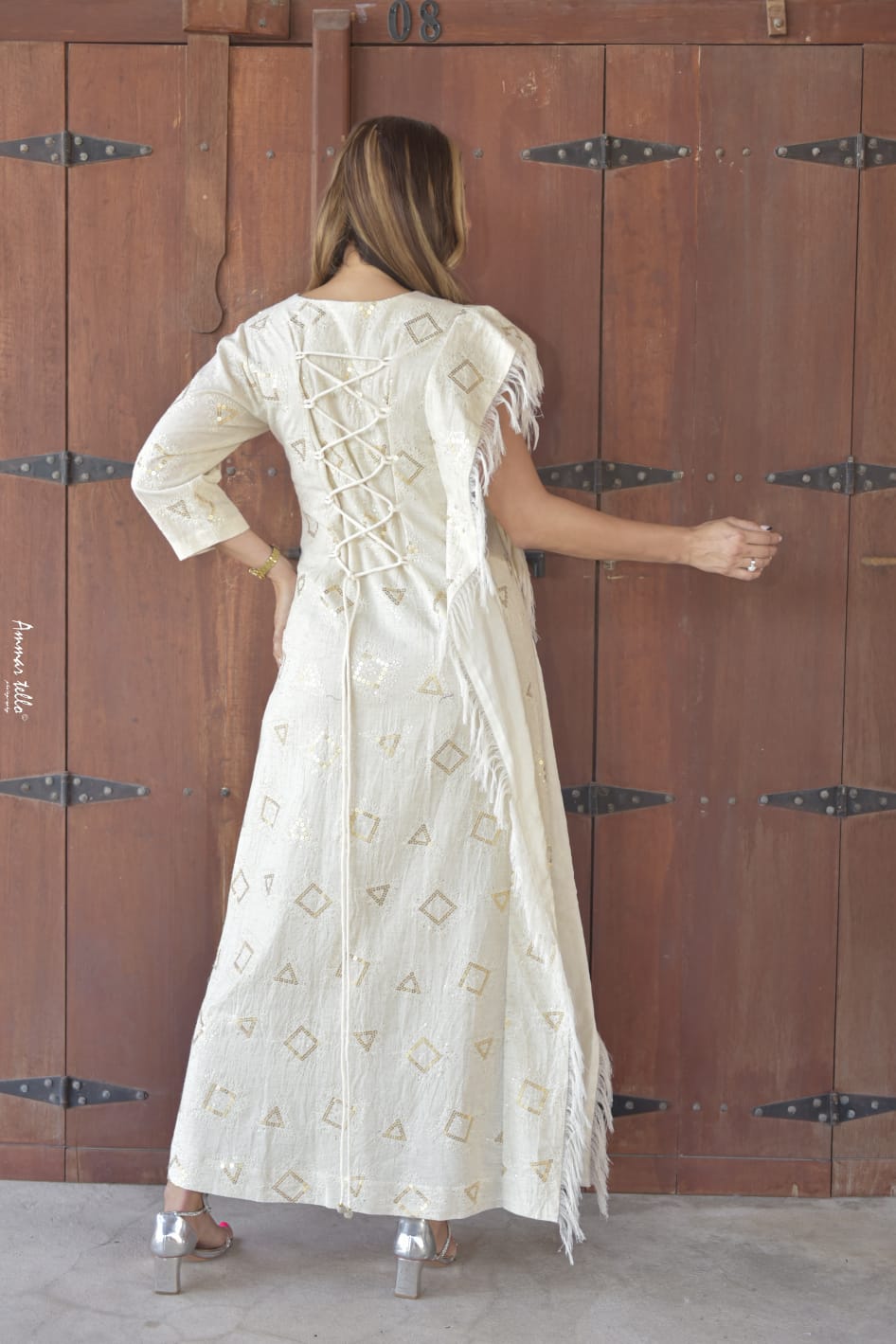 Beautiful modern dress with folk embroidery in geometric shapes with one sleeve