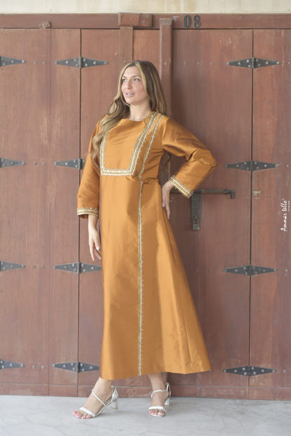 Loose bronze dress with a distinctive Arabic character &amp; straight cut decorated with handmade ruffles and ribbons