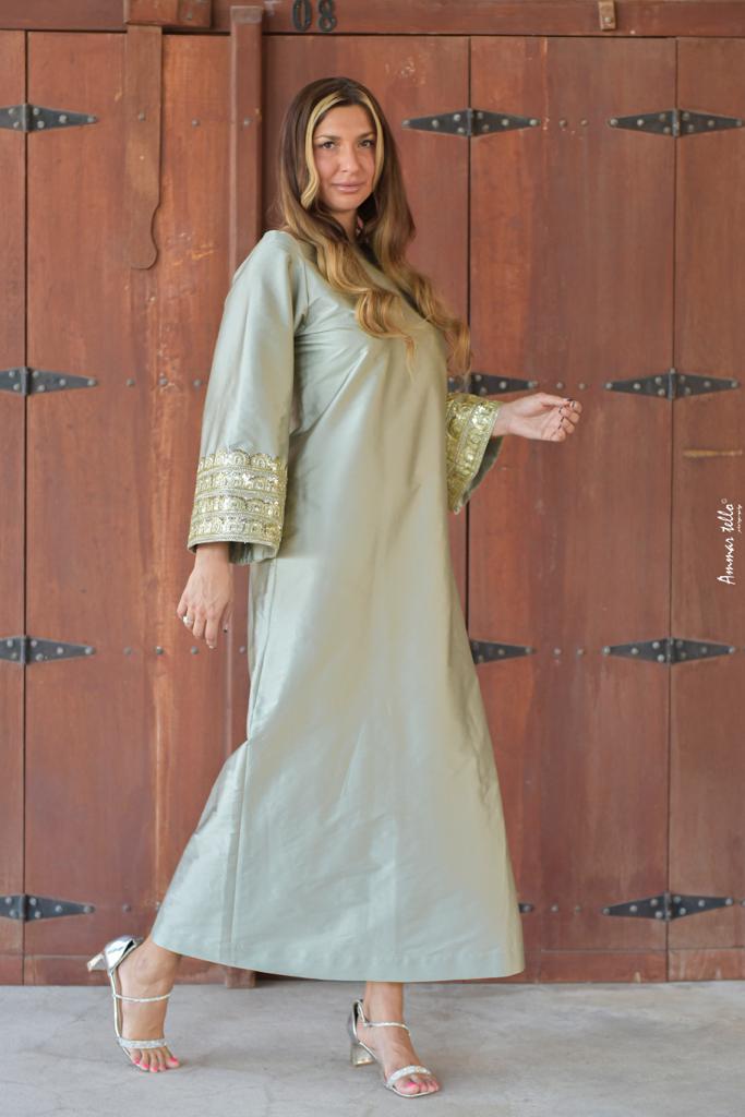 Arabic style dress with loose sleeves decorated with folk embroidery and beads