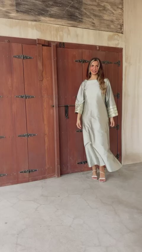 Arabic style dress with loose sleeves decorated with folk embroidery and beads